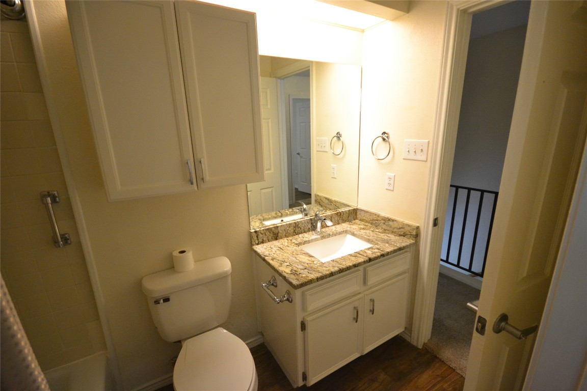 500 Hesters Crossing Road, Unit 205 Round Rock, TX 78681 - Photo 15 of 18 a bathroom with a granite countertop toilet sink and mirror