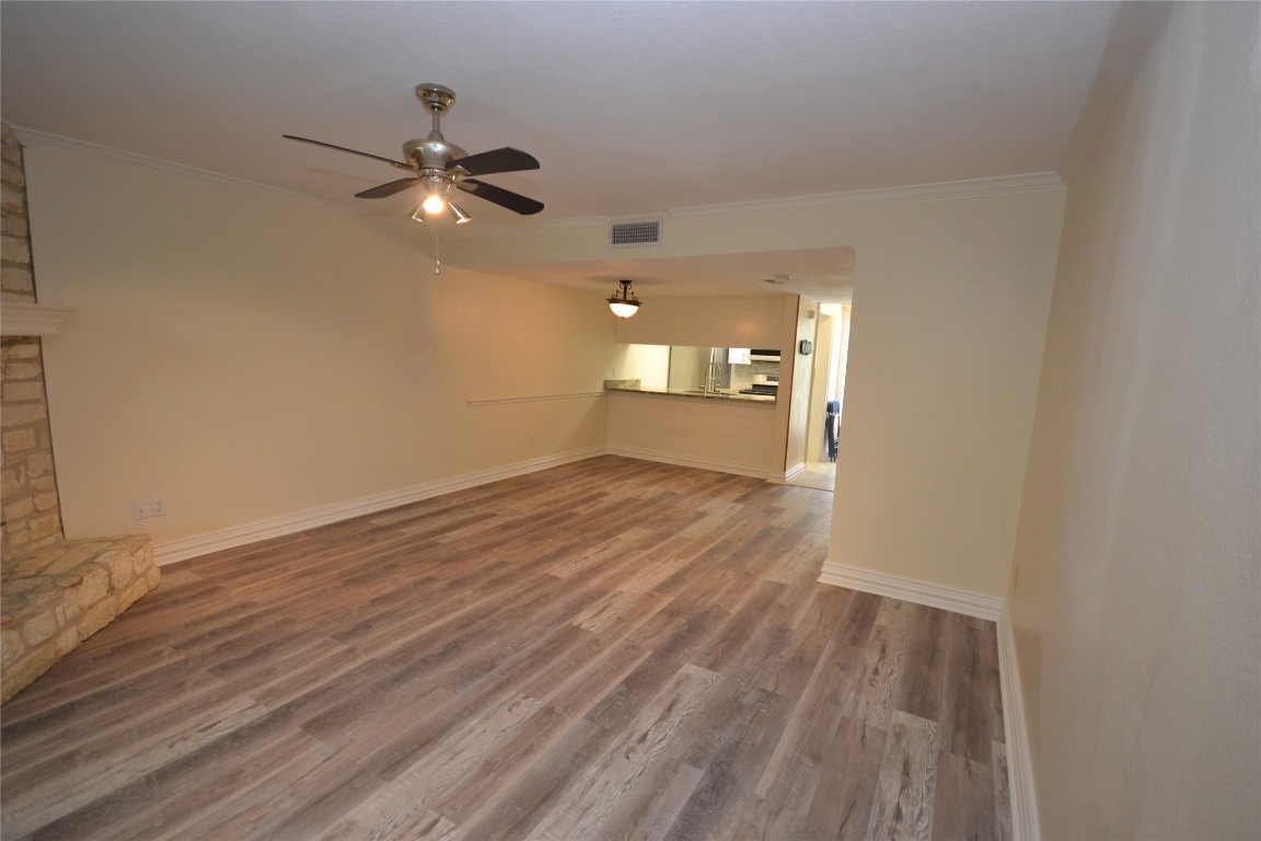 500 Hesters Crossing Road, Unit 205 Round Rock, TX 78681 - Photo 3 of 18 wooden floor in an empty room with a window