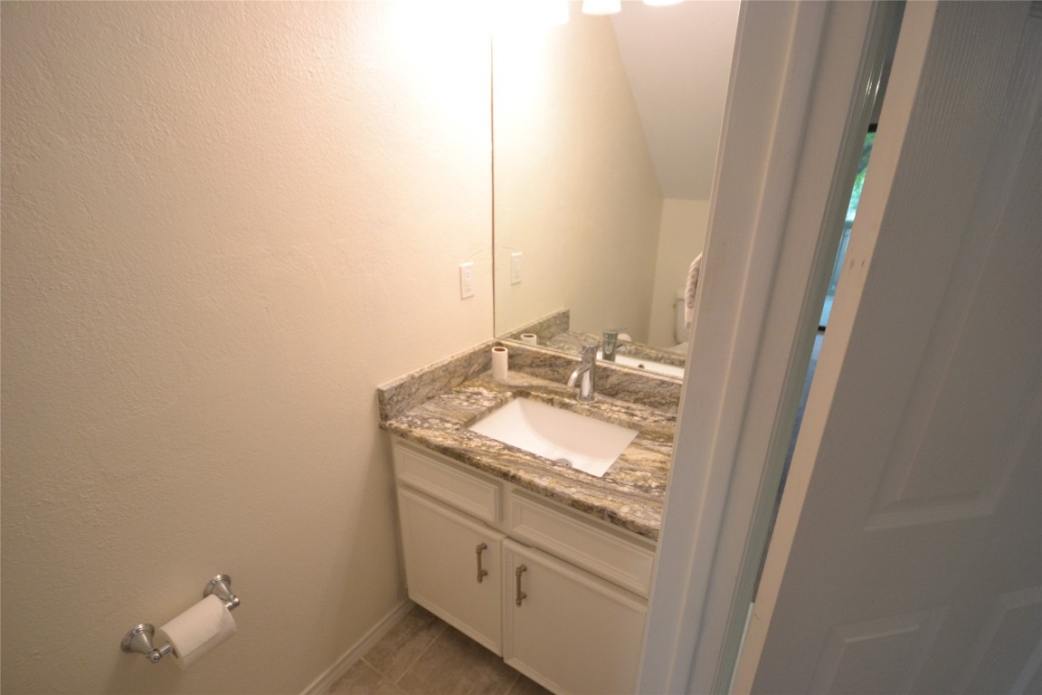 500 Hesters Crossing Road, Unit 205 Round Rock, TX 78681 - Photo 6 of 18 a bathroom with a granite countertop sink and a mirror