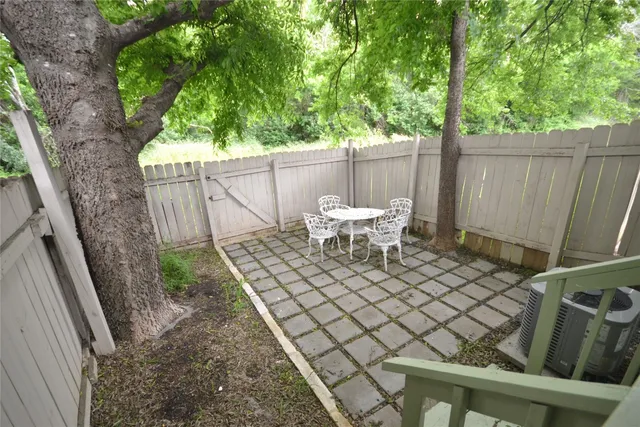 a white bench sitting in a backyard