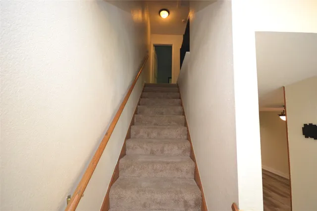 a view of a hallway with stairs