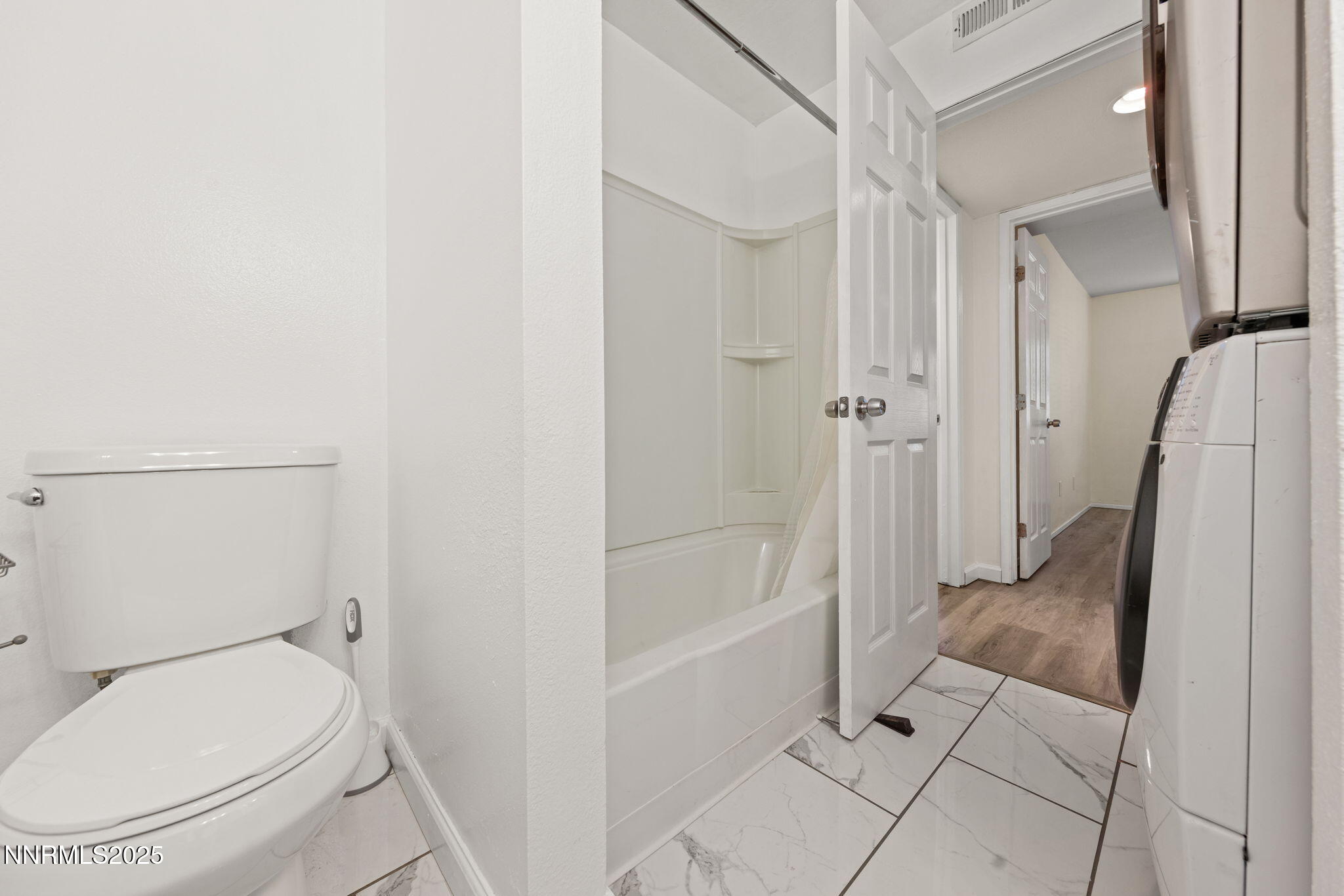 2555 Clear Acre Lane, Unit 161 Reno, NV 89512 - Photo 13 of 17 a bathroom with a granite countertop toilet and a shower