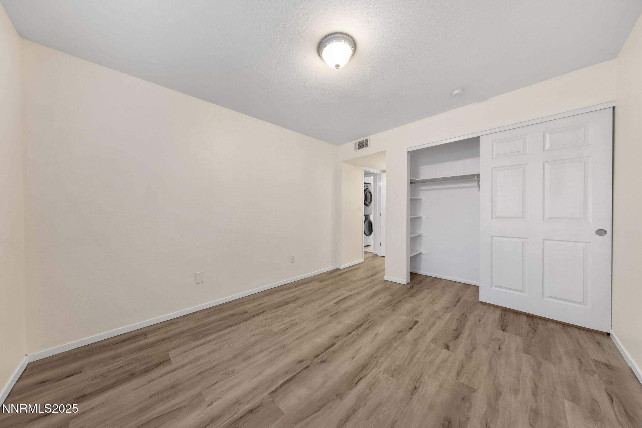 2555 Clear Acre Lane, Unit 161 Reno, NV 89512 - Photo 15 of 17 a view of an empty room with wooden floor