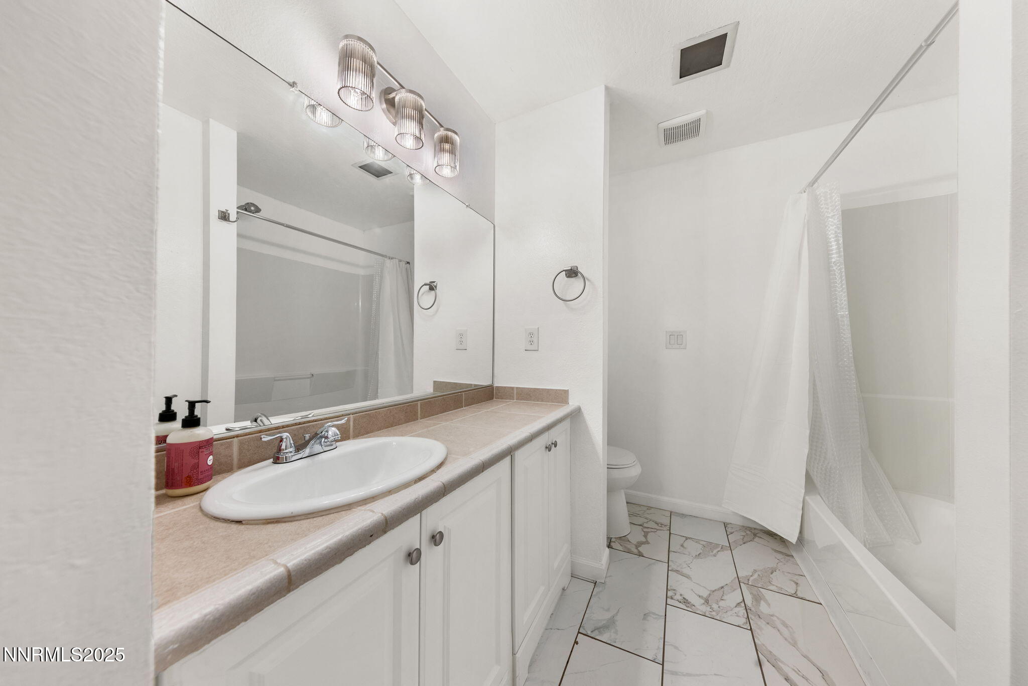 2555 Clear Acre Lane, Unit 161 Reno, NV 89512 - Photo 16 of 17 a bathroom with a granite countertop sink a mirror and a shower
