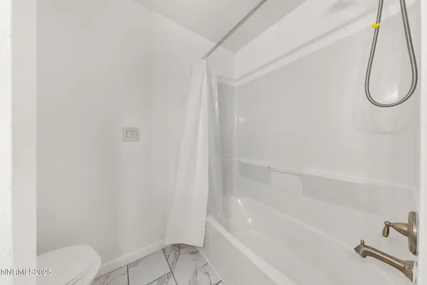 a bathroom with a shower and a toilet