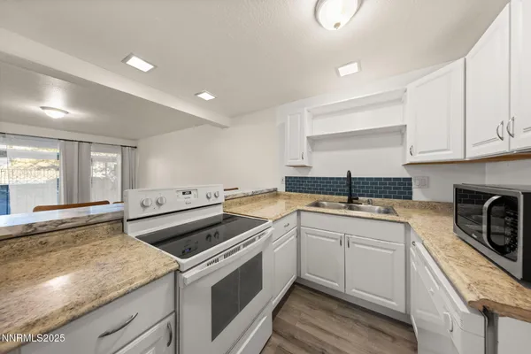 a kitchen with a sink stove and cabinets