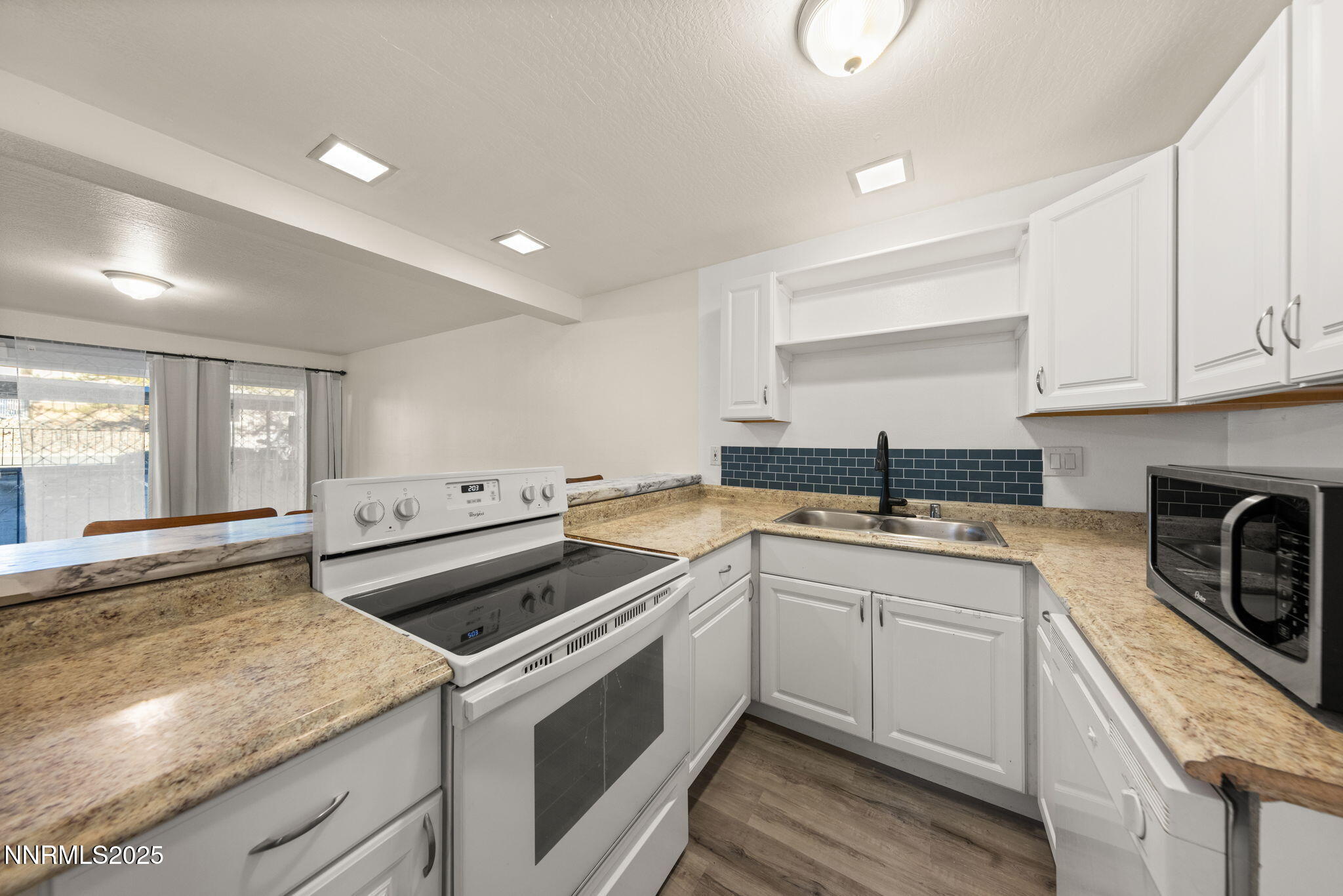 2555 Clear Acre Lane, Unit 161 Reno, NV 89512 - Photo 2 of 17 a kitchen with a sink stove and cabinets