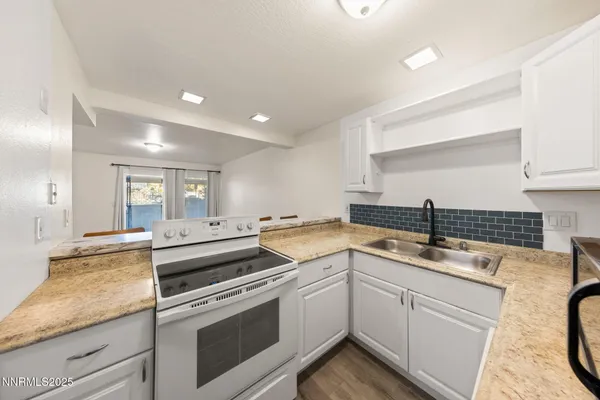 a kitchen with a sink stove and cabinets