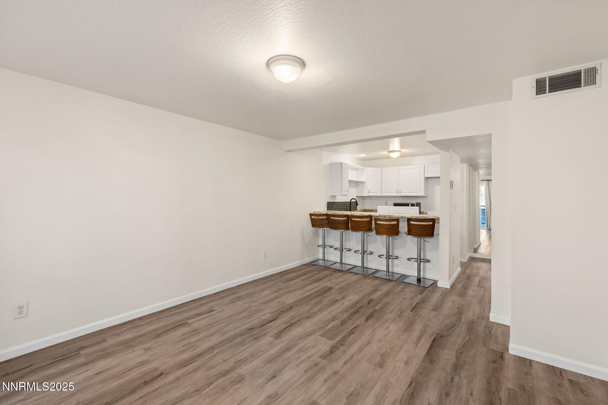 2555 Clear Acre Lane, Unit 161 Reno, NV 89512 - Photo 6 of 17 a room with wooden floor and a chair