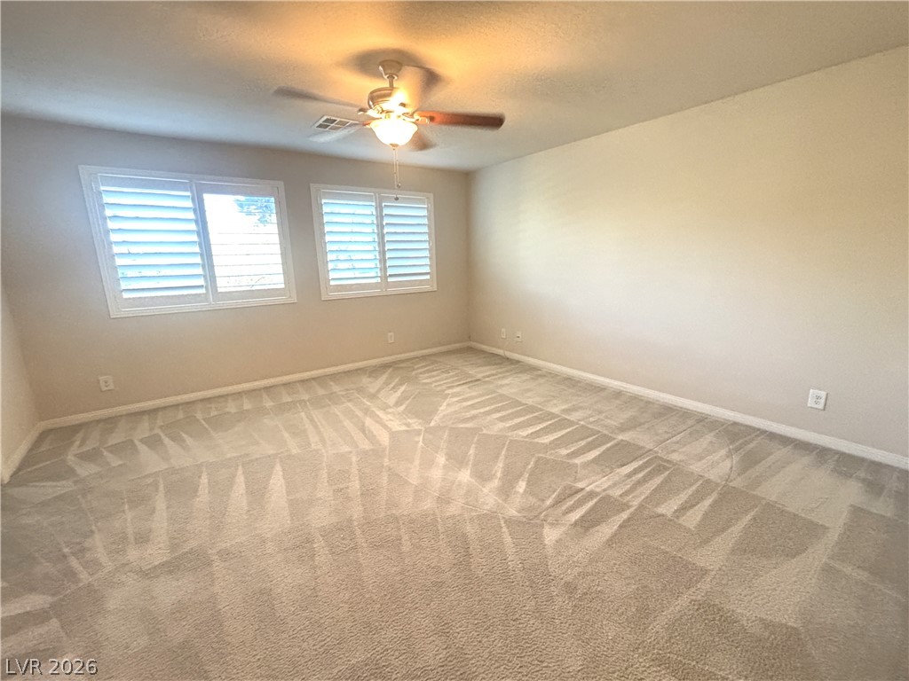 121 Elm Reed Avenue Las Vegas, NV 89113 - Photo 18 of 30 An airy bedroom with dual windows and a classic ceiling fan, ready for personal touches.