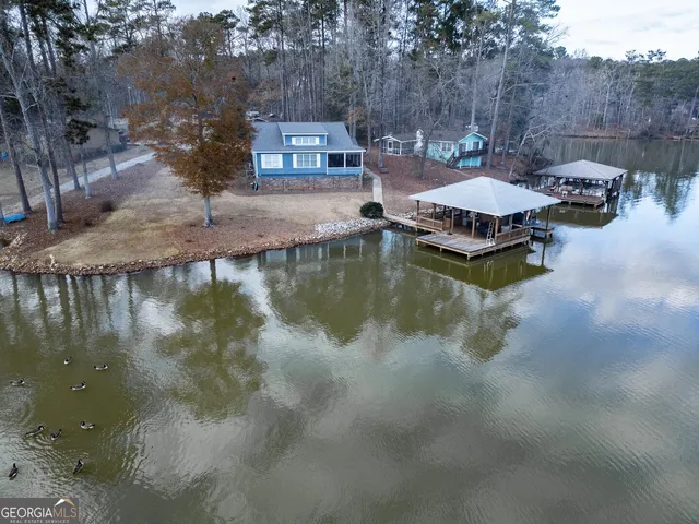 a view of swimming pool with outdoor seating and lake view