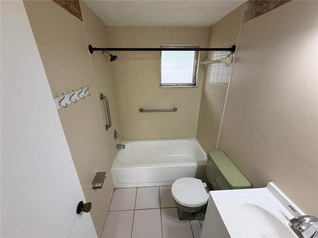 6330 Pennsylvania Avenue New Port Richey, FL 34653 - Photo 13 of 17 a bathroom with a sink a toilet and shower