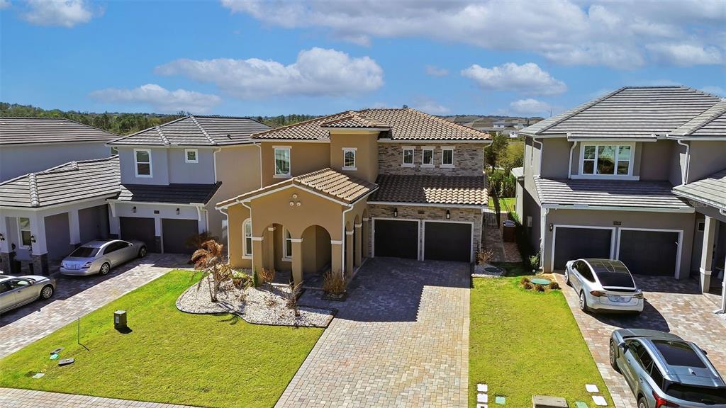 16131 Volterra Point Bella Collina, FL 34756 - Photo 1 of 52 a view of a big house with a big yard and potted plants