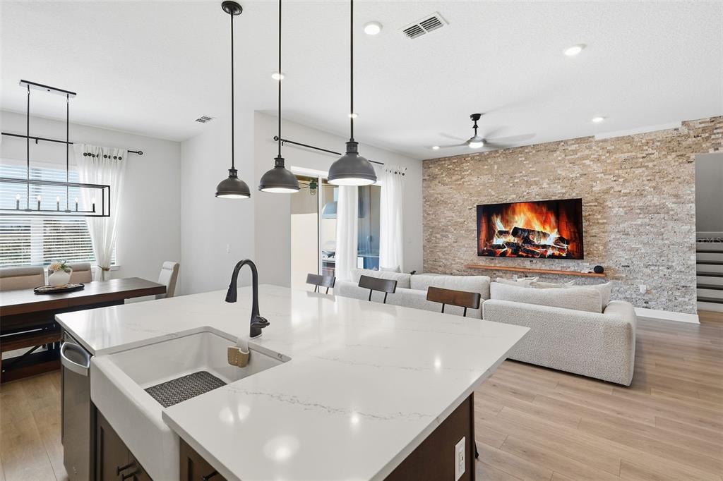 16131 Volterra Point Bella Collina, FL 34756 - Photo 11 of 52 a living room with furniture a flat screen tv and a chandelier