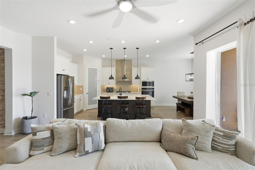 16131 Volterra Point Bella Collina, FL 34756 - Photo 15 of 52 a living room with furniture kitchen and a chandelier