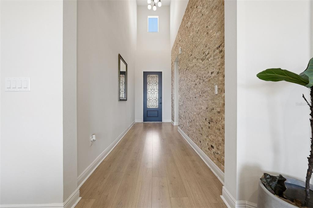 16131 Volterra Point Bella Collina, FL 34756 - Photo 16 of 52 a view of a hallway with wooden floor and staircase