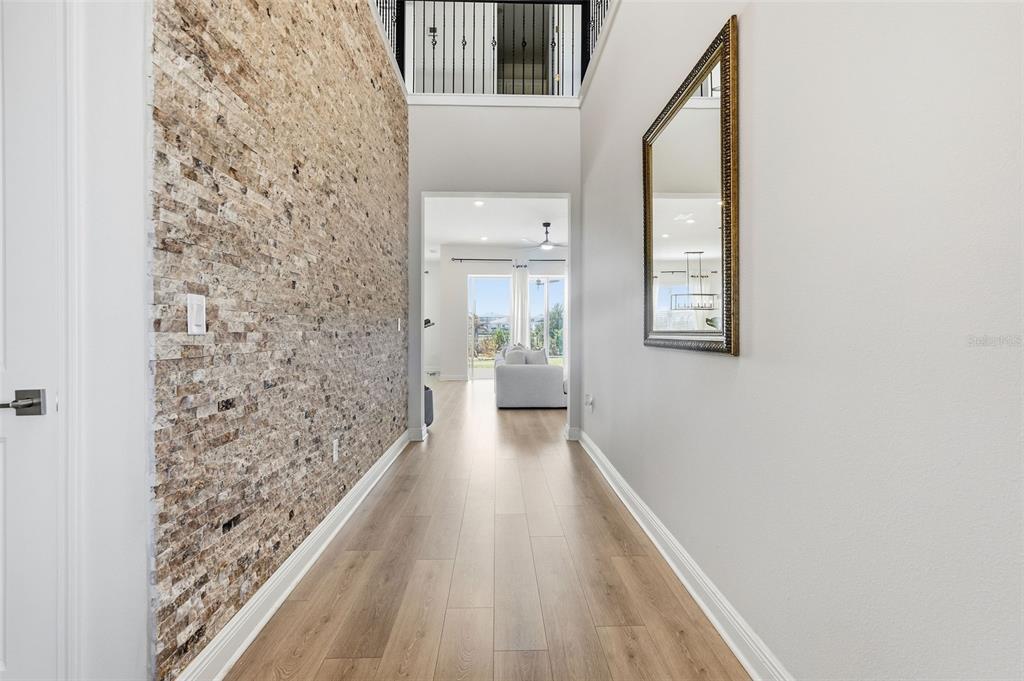 16131 Volterra Point Bella Collina, FL 34756 - Photo 17 of 52 a view of a hallway with wooden floor and a bathroom