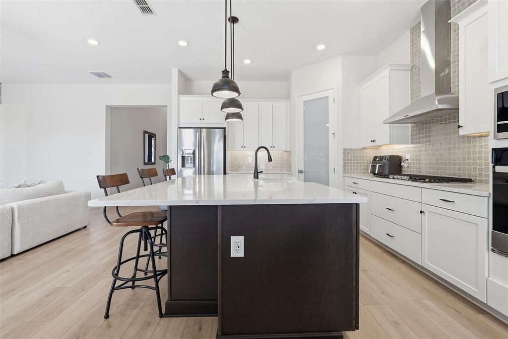 16131 Volterra Point Bella Collina, FL 34756 - Photo 21 of 52 a kitchen with kitchen island granite countertop a sink a center island and cabinets