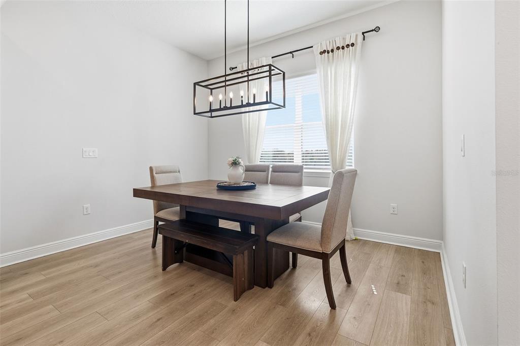 16131 Volterra Point Bella Collina, FL 34756 - Photo 24 of 52 a view of a dining room with a table and chairs