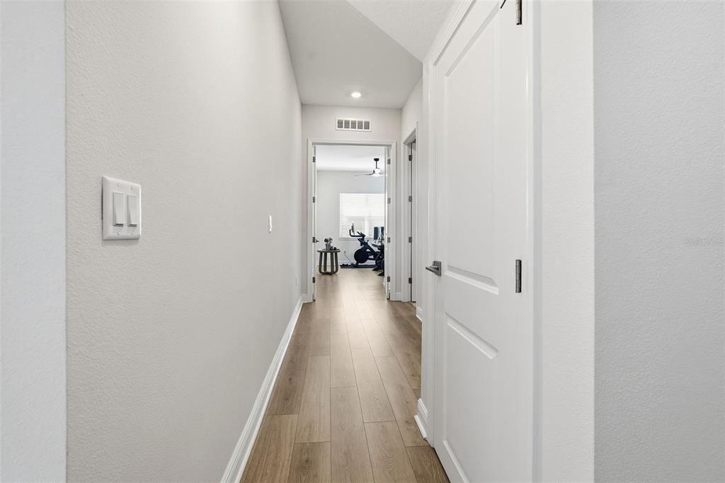 16131 Volterra Point Bella Collina, FL 34756 - Photo 25 of 52 a view of a hallway with wooden floor and a bathroom
