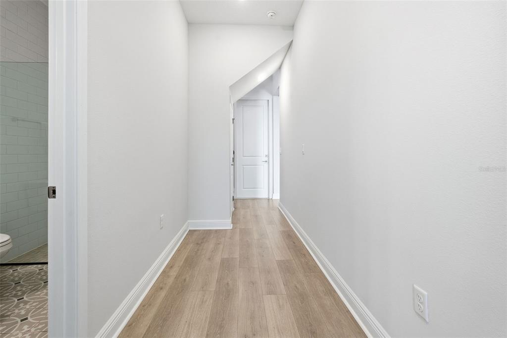 16131 Volterra Point Bella Collina, FL 34756 - Photo 28 of 52 a view of a hallway with wooden floor
