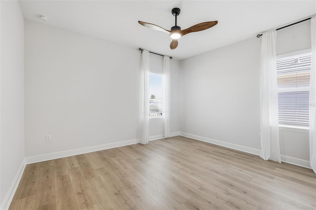 16131 Volterra Point Bella Collina, FL 34756 - Photo 37 of 52 an empty room with wooden floor and windows