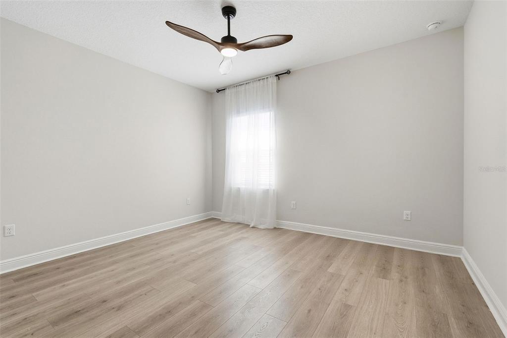 16131 Volterra Point Bella Collina, FL 34756 - Photo 39 of 52 an empty room with a window and a ceiling fan