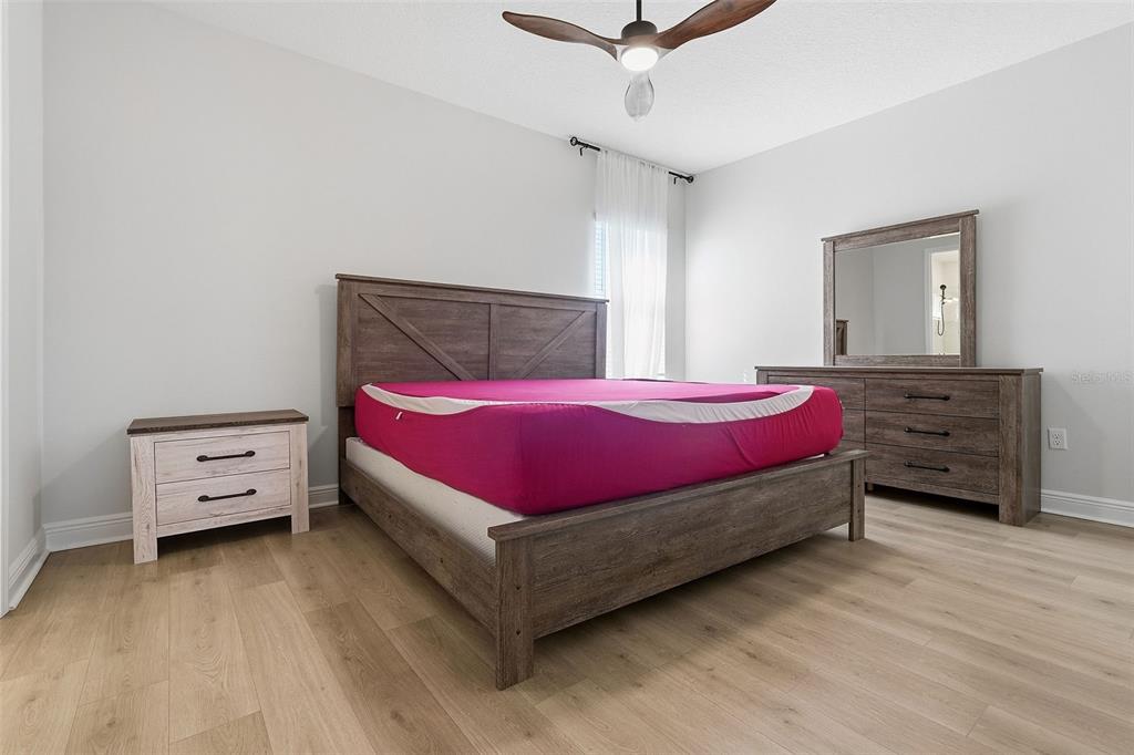 16131 Volterra Point Bella Collina, FL 34756 - Photo 42 of 52 a bedroom with a bed and a dresser