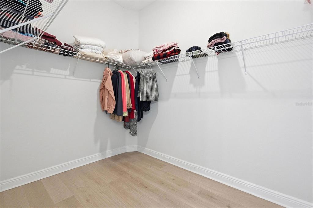 16131 Volterra Point Bella Collina, FL 34756 - Photo 44 of 52 a view of walk in closet with clothes and shoes