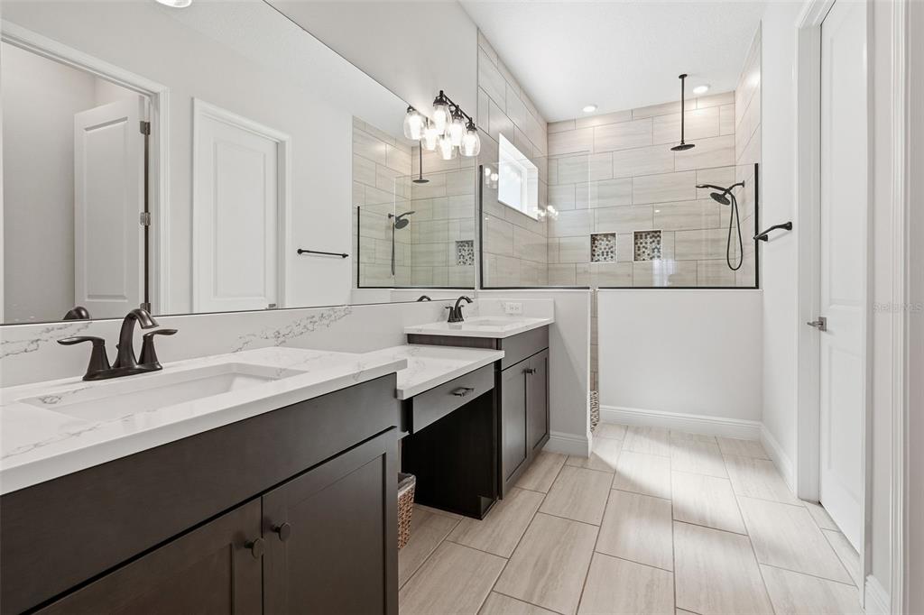 16131 Volterra Point Bella Collina, FL 34756 - Photo 9 of 52 a spacious bathroom with a double vanity sink a mirror and a shower