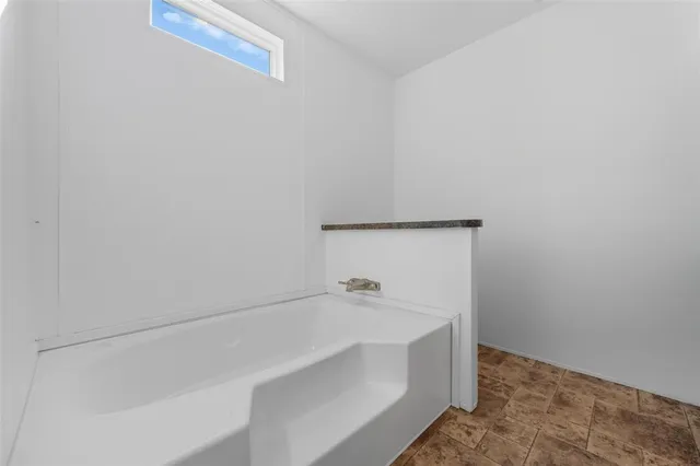 a bathroom with a granite countertop sink toilet a mirror and shower