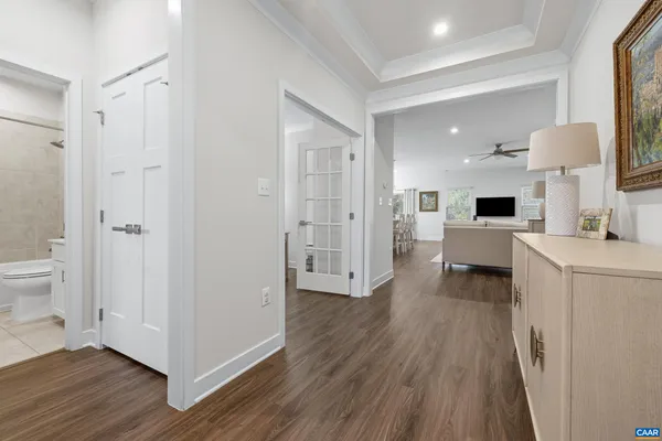 a view of a hallway with bathroom and wooden floor