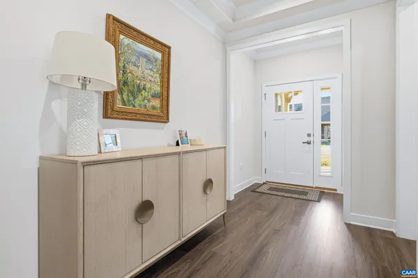 a view of kitchen with wooden floor and white doors