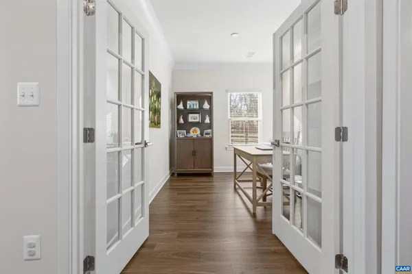 a view of an entryway with wooden floor