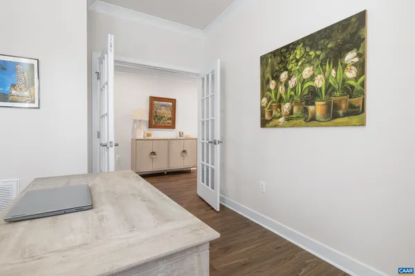 a bedroom with a bed and a painting on the wall