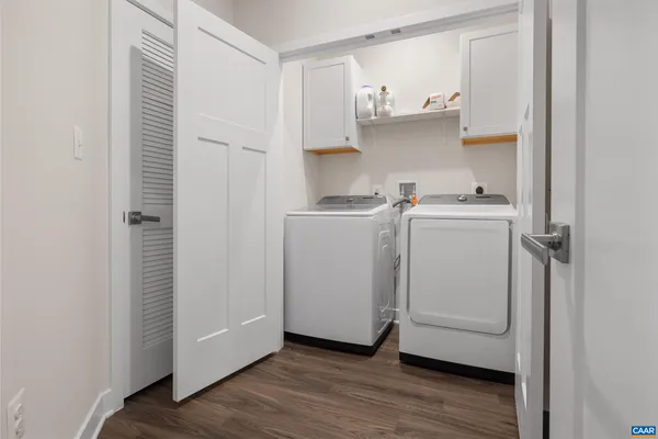 a storage room with wooden floor washer and dryer