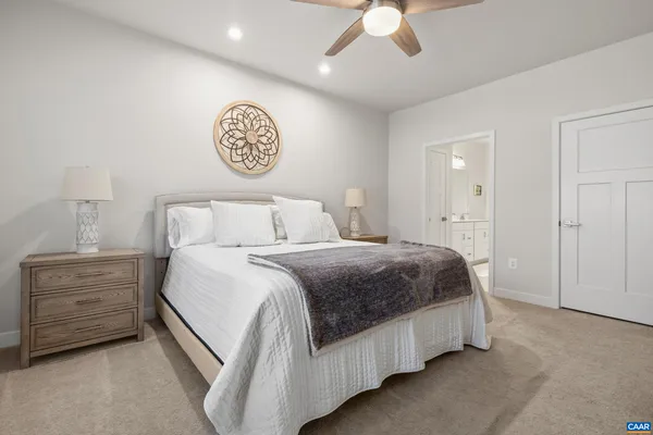 a bedroom with a bed and a lamp