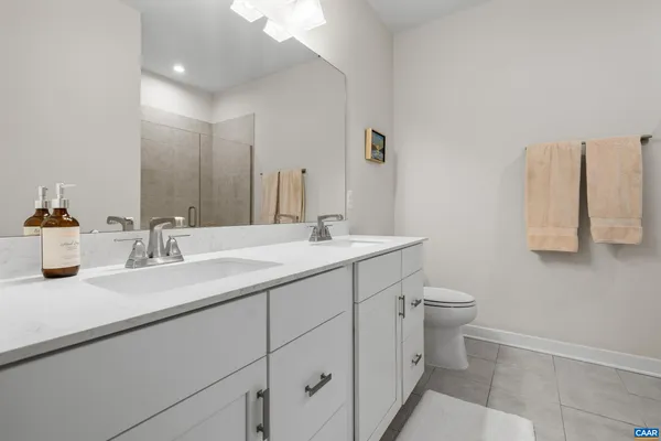 a bathroom with a sink a toilet and mirror