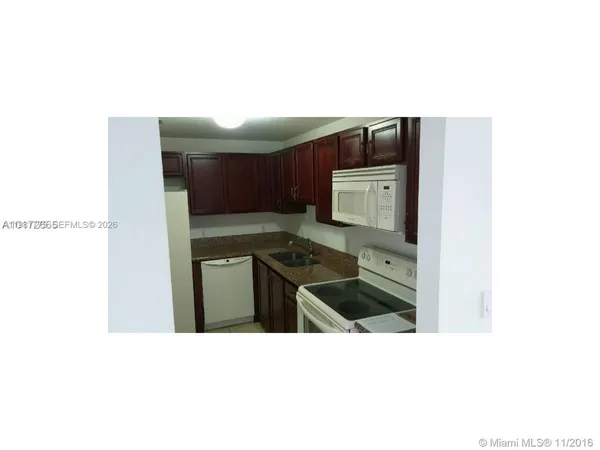 a kitchen with a sink cabinets and stainless steel appliances