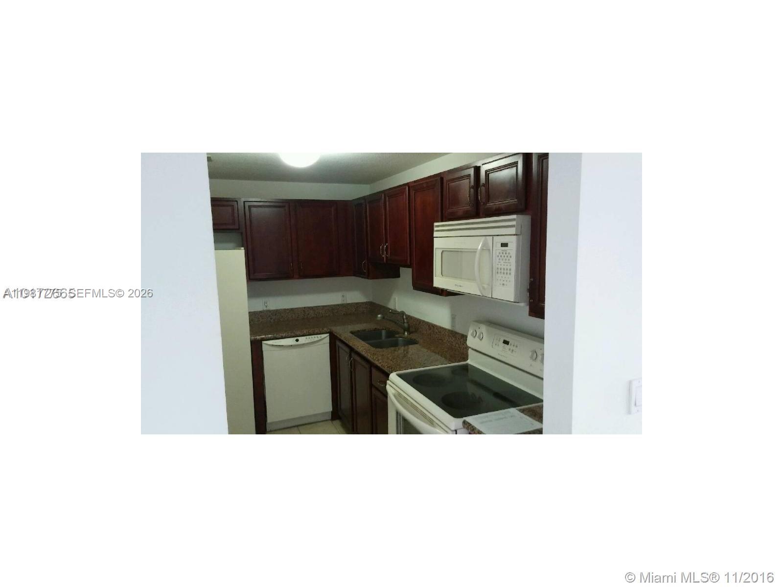 5271 Southwest 8th Street, Unit 314 Miami, FL 33134 - Photo 4 of 4 a kitchen with a sink cabinets and stainless steel appliances