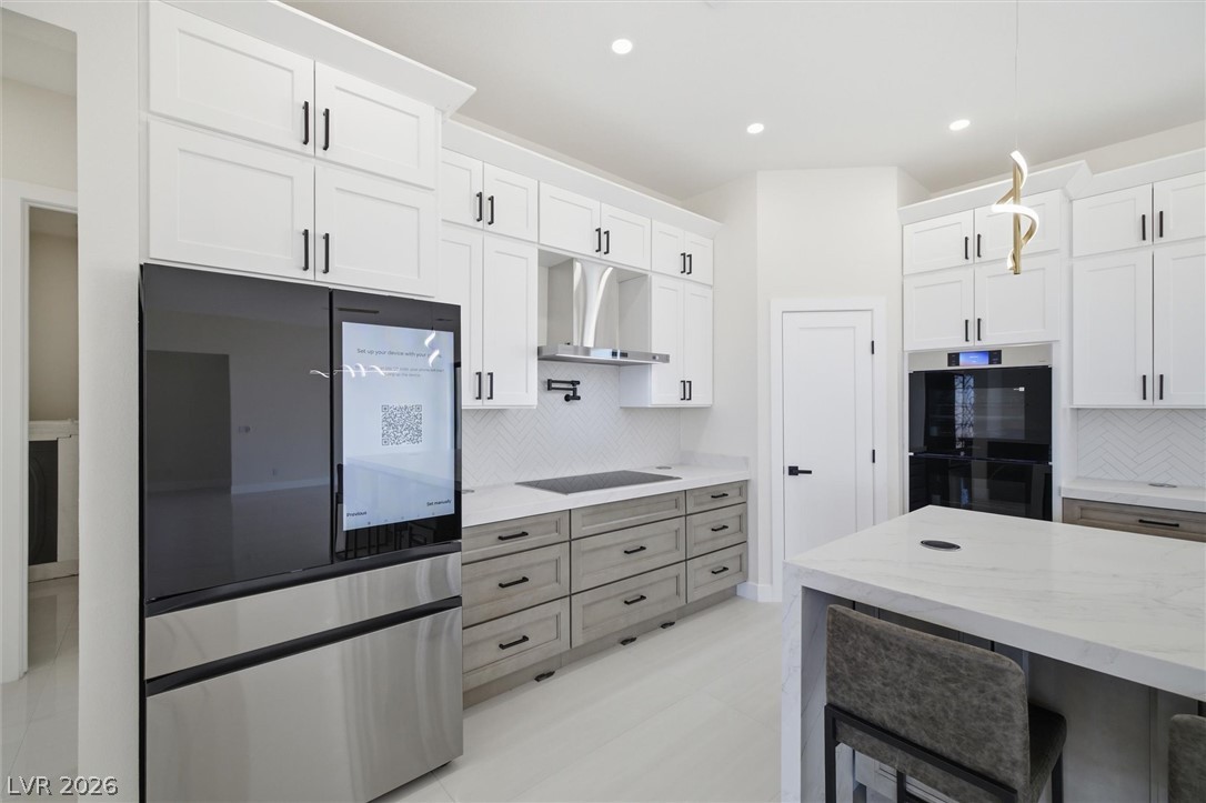 5910 East Kellogg Road Pahrump, NV 89061 - Photo 17 of 58 Modern cabinetry and appliances define this sleek, well-appointed culinary space.
