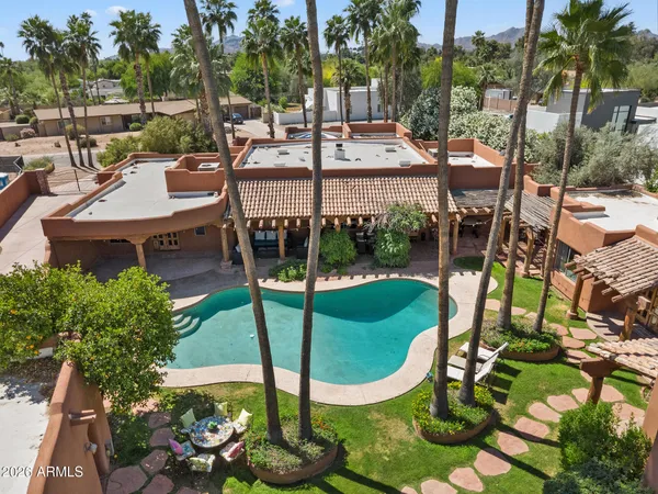 a view of a swimming pool with a patio and a garden