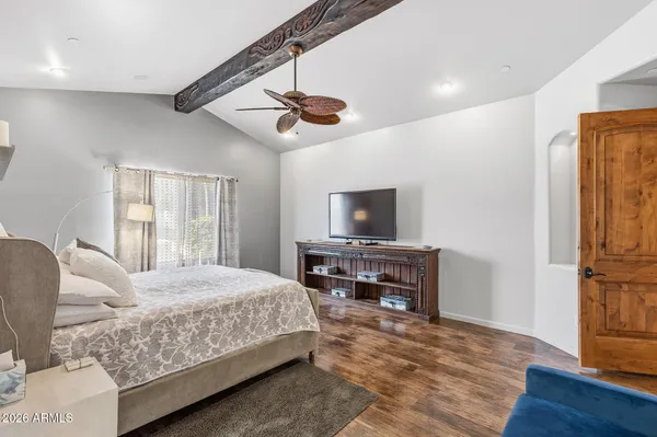 a bedroom with a bed and wooden floor