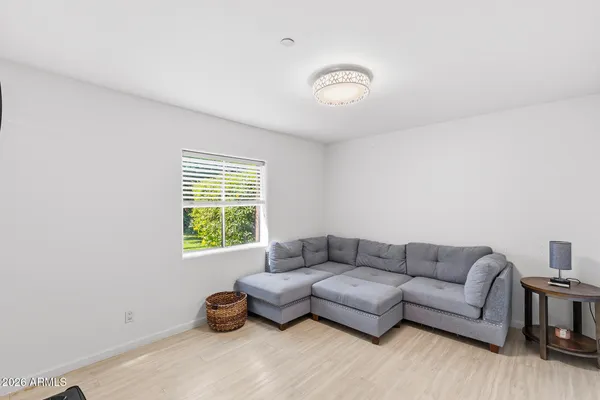 a bathroom with a granite countertop toilet sink and mirror