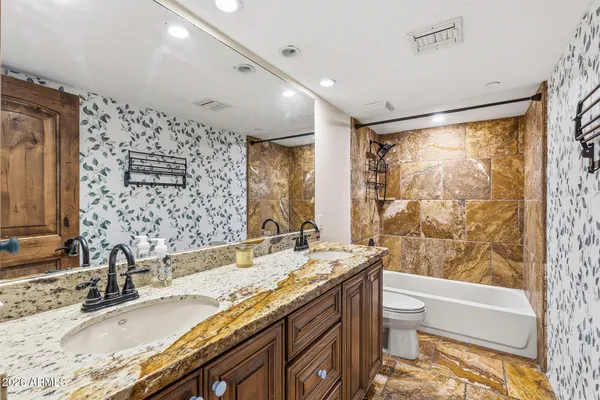 a bedroom with a bed and a chair