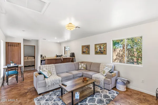 a view of a house with a backyard and a tree