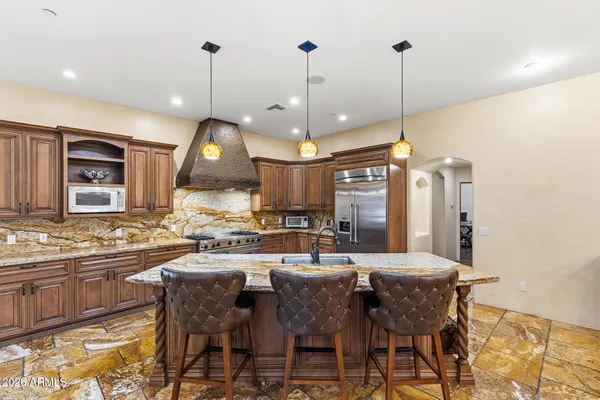 a bathroom with a granite countertop sink toilet and a mirror