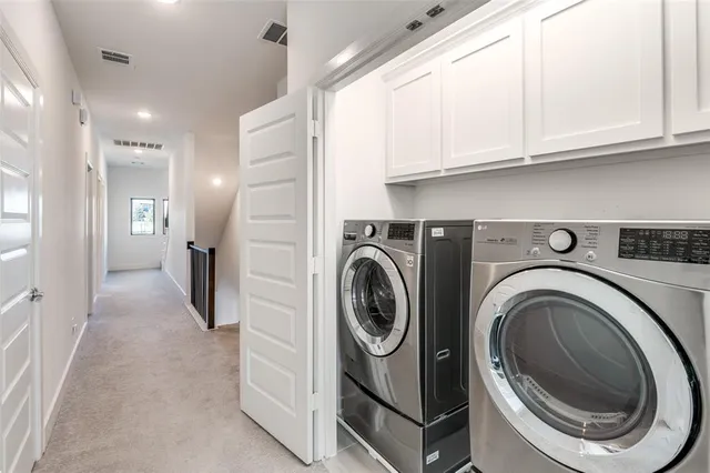 a view of a hallway with washer and dryer