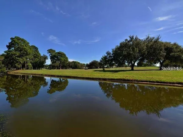 a view of a lake with houses in the back