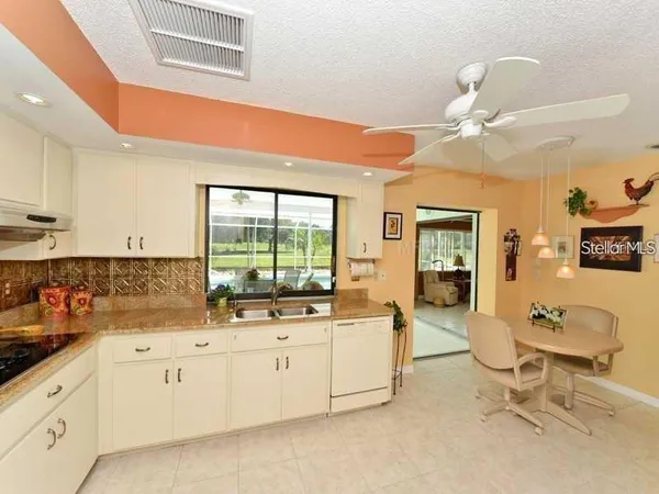 a large white kitchen with a large window